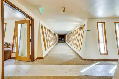 an empty hallway in a house with windows at Convenient Winter Park, Colorado, Vacation Rental! in Winter Park