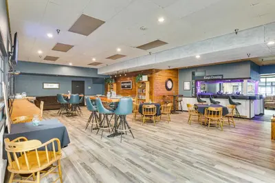 a restaurant with tables and chairs and a bar at Convenient Winter Park, Colorado, Vacation Rental! in Winter Park