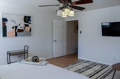 a bedroom with a bed and a ceiling fan at Change Your Altitude in Denver 3BR near Denver Airport w/GameRoom in Denver