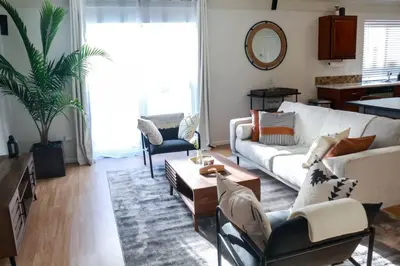 a living room with a couch and a table at Change Your Altitude in Denver 3BR near Denver Airport w/GameRoom in Denver