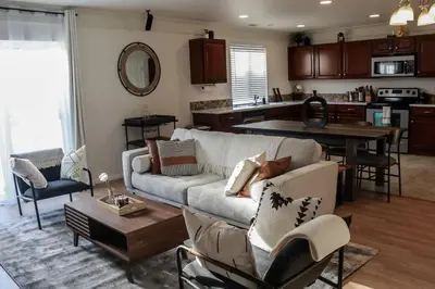 a living room with a couch and a table at Change Your Altitude in Denver 3BR near Denver Airport w/GameRoom in Denver