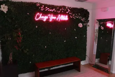 a ivy covered wall with a neon sign on it at Change Your Altitude in Denver 3BR near Denver Airport w/GameRoom in Denver