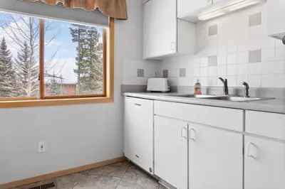 a kitchen with white cabinets and a window at Cozy Frisco Condo Near Lake and Trails in Frisco