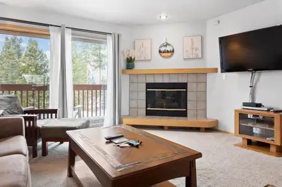a living room with a fireplace and a tv at Cozy Frisco Condo Near Lake and Trails in Frisco