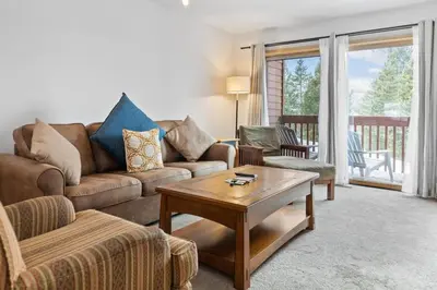 a living room with a couch and a coffee table at Cozy Frisco Condo Near Lake and Trails in Frisco