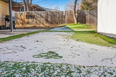 a driveway with snow on the ground in a yard at Golfers Dream! Sweet NW location. in Arvada
