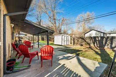 a porch with four red chairs at Golfers Dream! Sweet NW location. in Arvada
