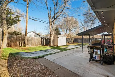 a backyard with a fence and a driveway at Golfers Dream! Sweet NW location. in Arvada