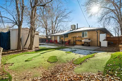 a small house with a yard and a fence at Golfers Dream! Sweet NW location. in Arvada