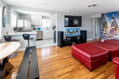 a living room with a red couch and a kitchen at Hidden Gem of Arvada! in Arvada