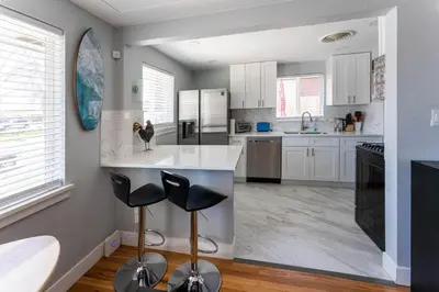 a kitchen with white cabinets and black appliances at Hidden Gem of Arvada! in Arvada
