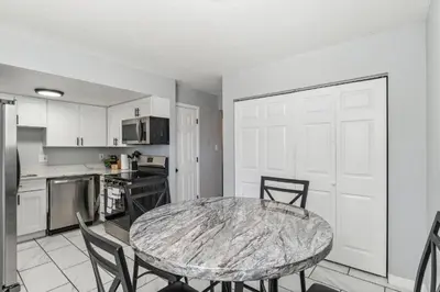 a kitchen with a table and chairs in a room at All New! Convenient Location! Sleeps 6 in Denver