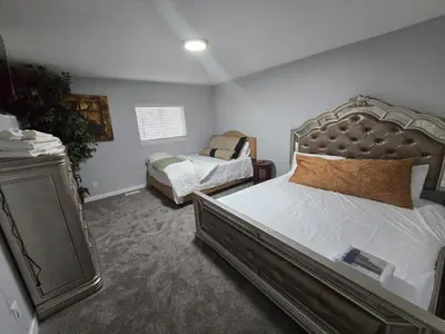 a bedroom with a bed and a dresser in it at All New! Convenient Location! Sleeps 6 in Denver