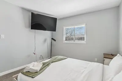 a bedroom with a white bed and a window at All New! Convenient Location! Sleeps 6 in Denver