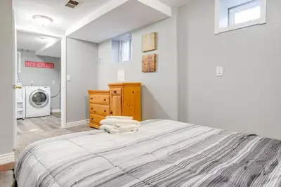 a bedroom with a bed and a washing machine at Less Than 1 Mi to Washington Park Denver Vacation Rental in Denver