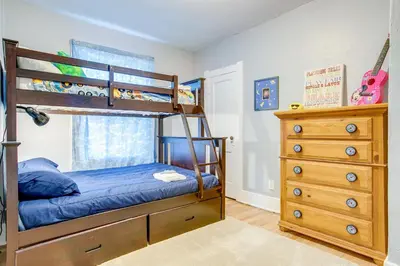a bedroom with a bunk bed and a dresser at Less Than 1 Mi to Washington Park Denver Vacation Rental in Denver