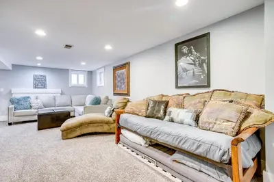 a living room with a couch and a living room with a couch at Less Than 1 Mi to Washington Park Denver Vacation Rental in Denver