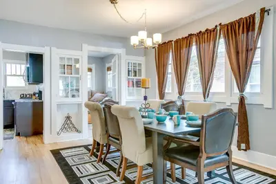 a dining room and living room with a table and chairs at Less Than 1 Mi to Washington Park Denver Vacation Rental in Denver