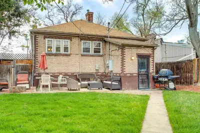 a house with a grill in a yard at Less Than 1 Mi to Washington Park Denver Vacation Rental in Denver