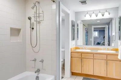 a bathroom with a shower and a tub and a sink at Less Than 1 Mi to Washington Park Denver Vacation Rental in Denver