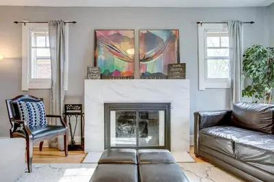 a living room with a couch and a fireplace at Less Than 1 Mi to Washington Park Denver Vacation Rental in Denver
