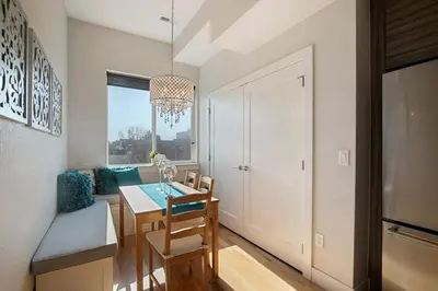 a dining room and kitchen with a table and chairs at 2 BDR Home Roof Deck plus Walk to Broncos and Sloans Lake in Denver