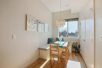 a dining room with a table and chairs and a window at 2 BDR Home Roof Deck plus Walk to Broncos and Sloans Lake in Denver