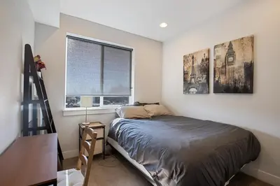 a small bedroom with a bed and a window at 2 BDR Home Roof Deck plus Walk to Broncos and Sloans Lake in Denver