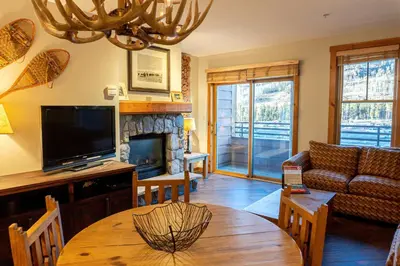 a living room with a couch and a fireplace at 2BR Ski In Ski Out Keystone Condo Walk to Slopes in Dillon