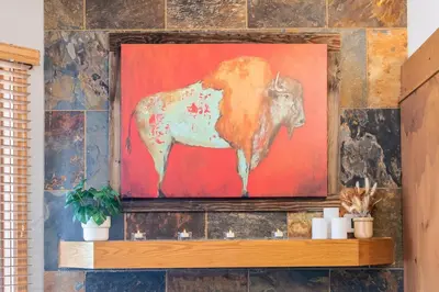 a painting of a cow on a wall at Iron Horse C5013 condo in Winter Park