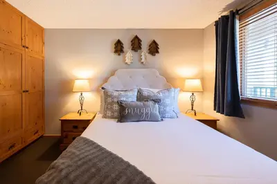 a bedroom with a large white bed with pillows at Iron Horse C5013 condo in Winter Park