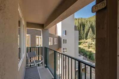 a balcony with a chair and a view of a mountain at Iron Horse C5013 condo in Winter Park