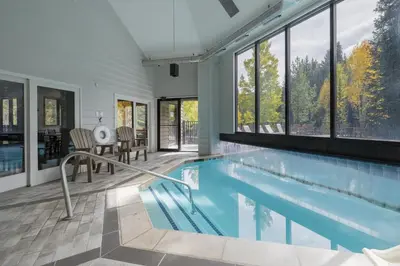 a swimming pool in a house with windows at Iron Horse C3013 condo in Winter Park