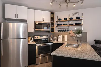 a kitchen with a stainless steel refrigerator and a sink at Iron Horse C3013 condo in Winter Park