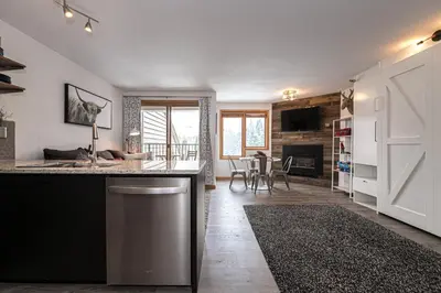 a kitchen with a counter and a living room at Iron Horse C3013 condo in Winter Park