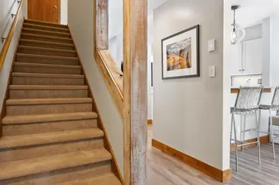 a staircase in a home with wooden railings at 2BR Keystone Condo Near Slopes in Keystone