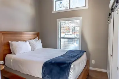 a bedroom with a bed and a window at 2BR Riverside Chalet Near Trails in Breckenridge