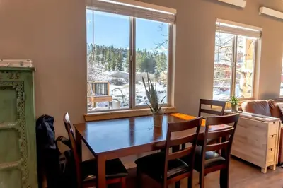 a dining room with a table and chairs and a window at 2BR Riverside Chalet Near Trails in Breckenridge