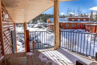 a balcony of a cabin with snow on the ground at 2BR Riverside Chalet Near Trails in Breckenridge