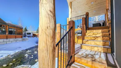 a stairway leading to a cabin with snow on the ground at 2BR Riverside Chalet Near Trails in Breckenridge