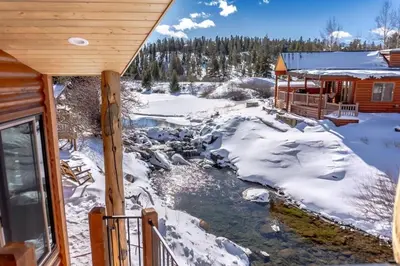 a winter view of a creek outside a cabin at 2BR Riverside Chalet Near Trails in Breckenridge