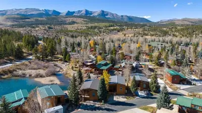 an aerial view of a resort with mountains in the background at 2BR Riverside Cabin Near Trails with Hot Tub Access in Breckenridge