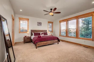 a bedroom with a bed and a ceiling fan at BEST VIEWS! Luxury Mountain Home - Saltwater HotTub, Firepit, BBQ- Close to SKI, Red Rocks in Evergreen