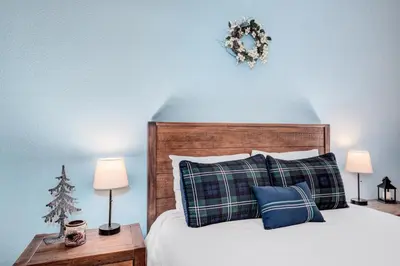 a bedroom with a bed with a wreath on the wall at BEST VIEWS! Luxury Mountain Home - Saltwater HotTub, Firepit, BBQ- Close to SKI, Red Rocks in Evergreen