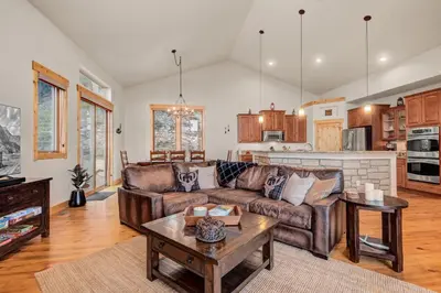 a living room with a couch and a table at BEST VIEWS! Luxury Mountain Home - Saltwater HotTub, Firepit, BBQ- Close to SKI, Red Rocks in Evergreen