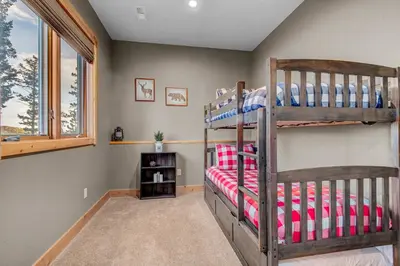 a bedroom with two bunk beds and a window at BEST VIEWS! Luxury Mountain Home - Saltwater HotTub, Firepit, BBQ- Close to SKI, Red Rocks in Evergreen