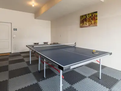 a ping pong table in an empty room with at BEST VIEWS! Luxury Mountain Home - Saltwater HotTub, Firepit, BBQ- Close to SKI, Red Rocks in Evergreen