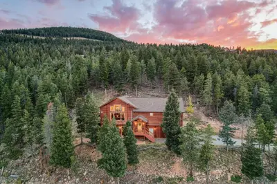 an aerial view of a wooden house in the woods at BEST VIEWS! Luxury Mountain Home - Saltwater HotTub, Firepit, BBQ- Close to SKI, Red Rocks in Evergreen