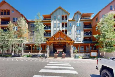 a large apartment building with a parking lot at Buffalo Lodge 1 Bedroom In River Run in Keystone