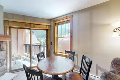 a dining room with a wooden table and chairs at Buffalo Lodge 1 Bedroom In River Run in Keystone